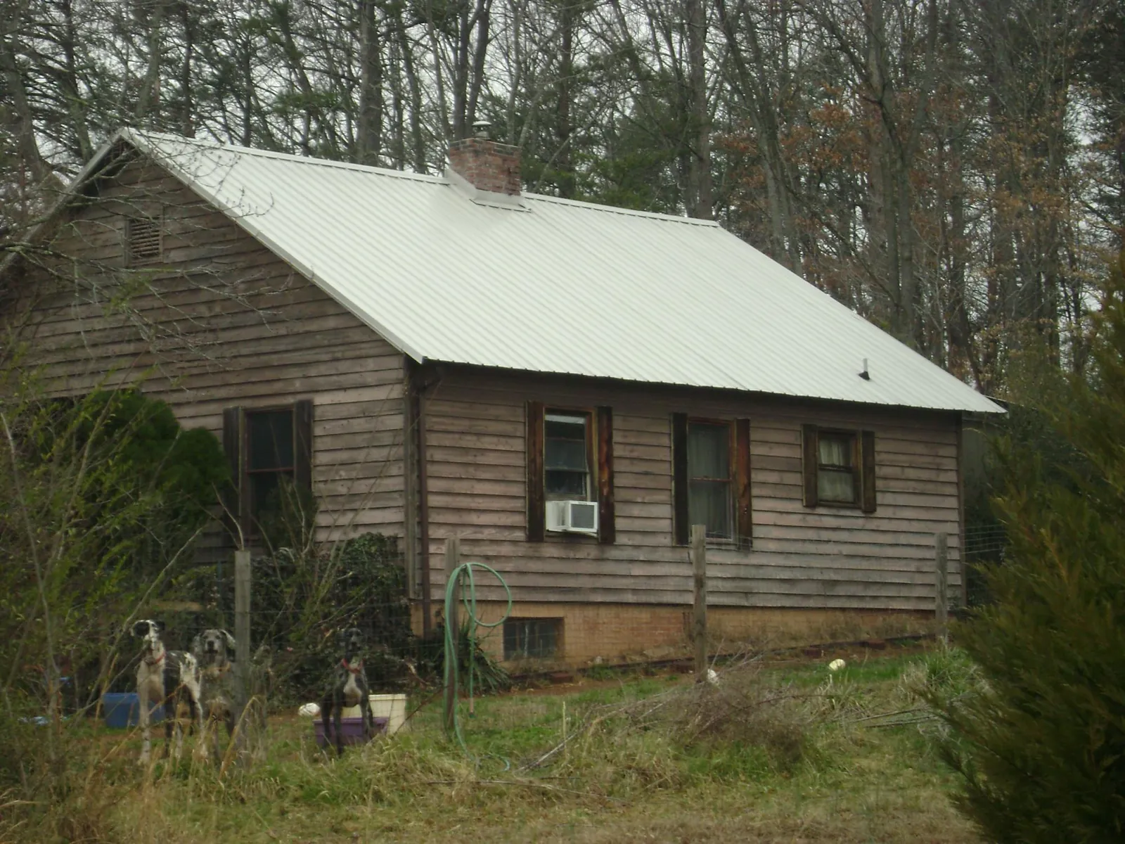 White metal roof on an old wood sided farmhouse, from a Metal Roof Installation job in Mantua